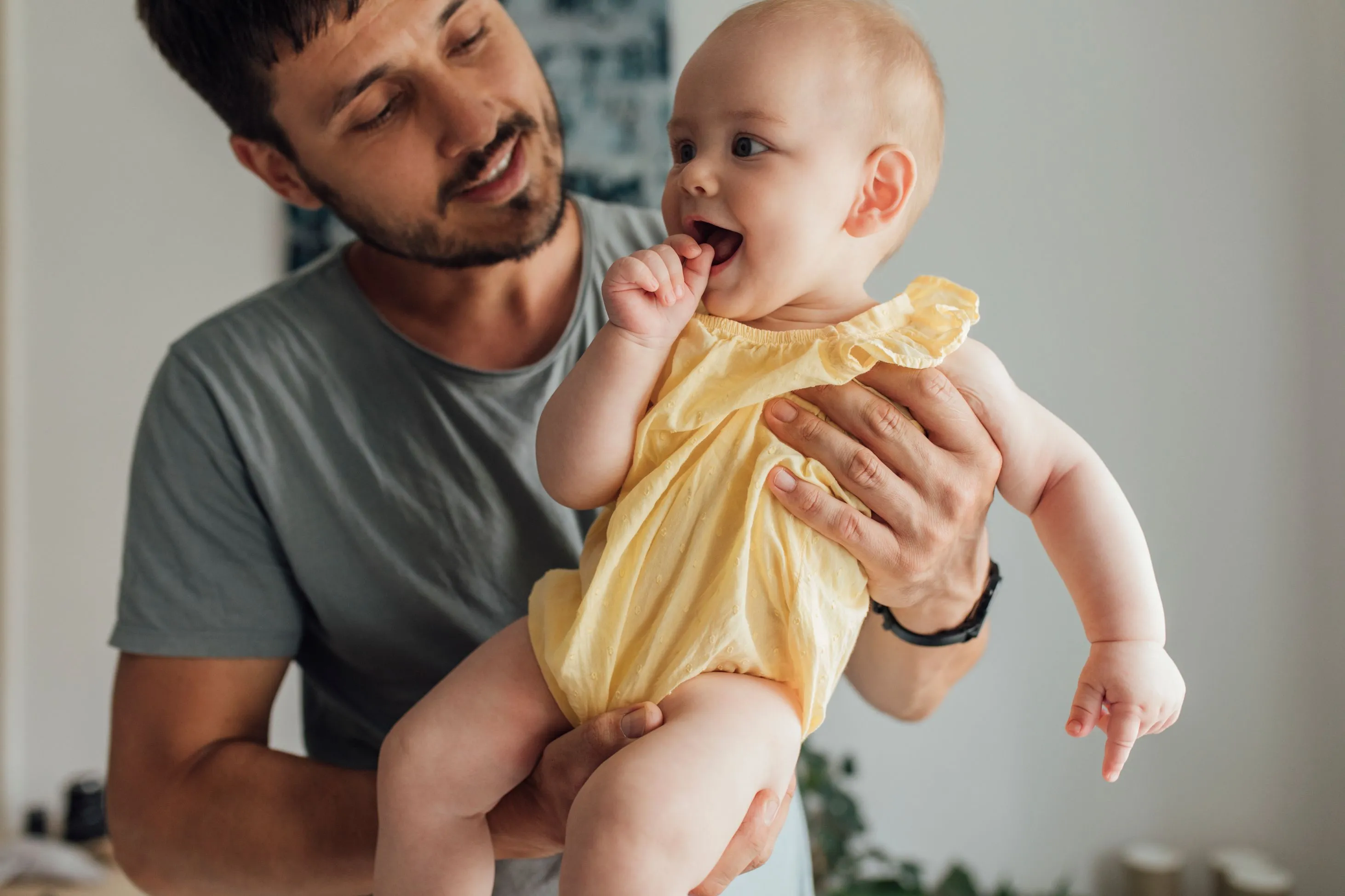 Father holding baby daughter