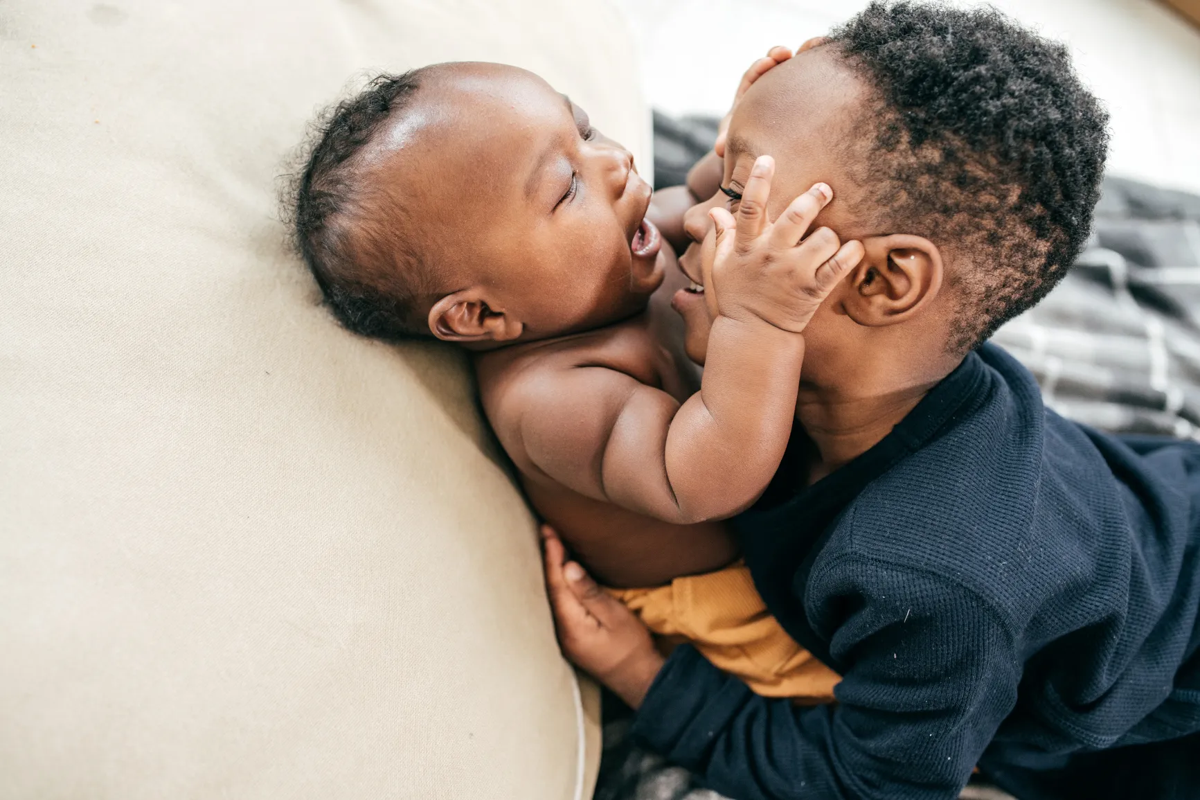 Baby and sibling playing