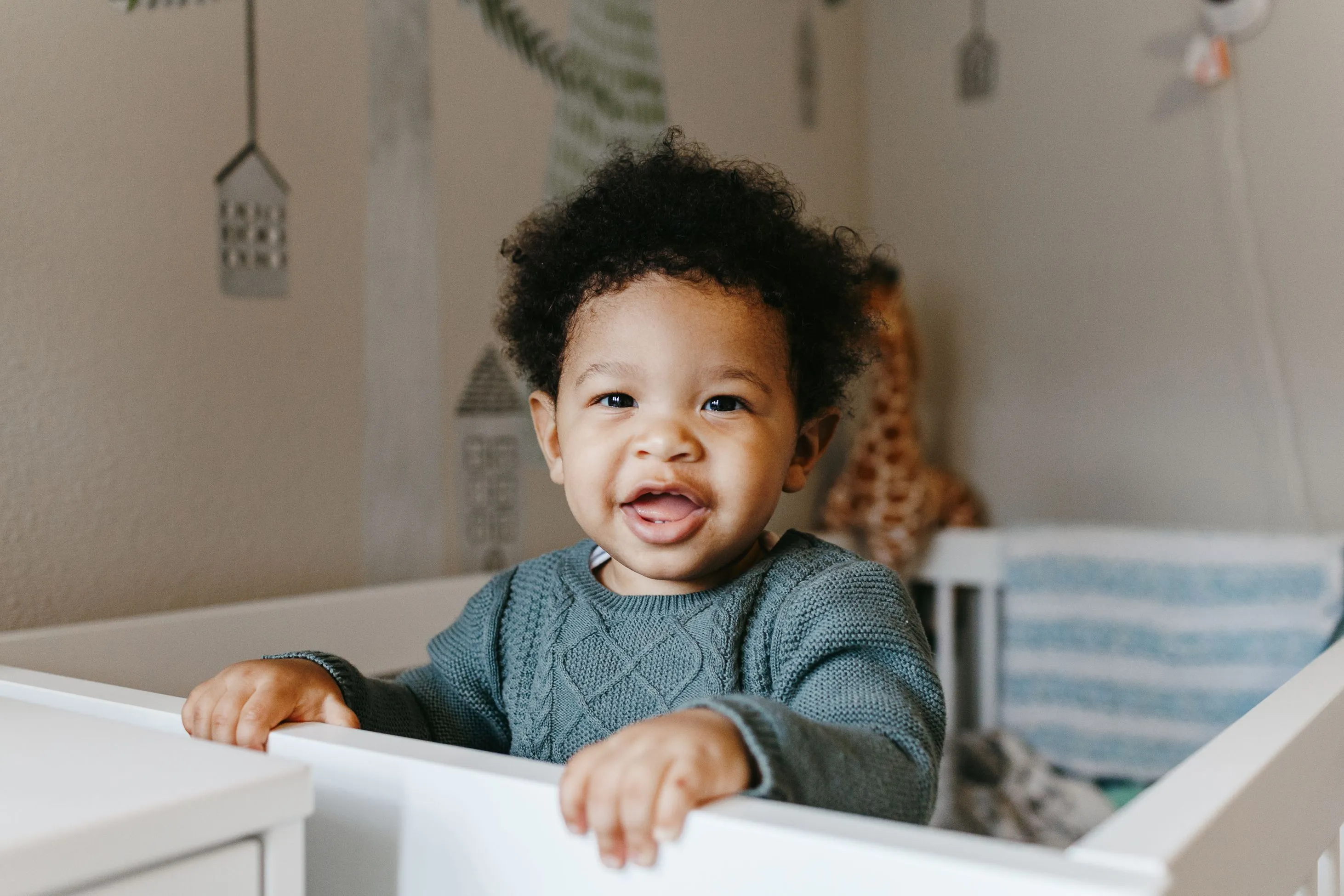 Baby smiling in crib