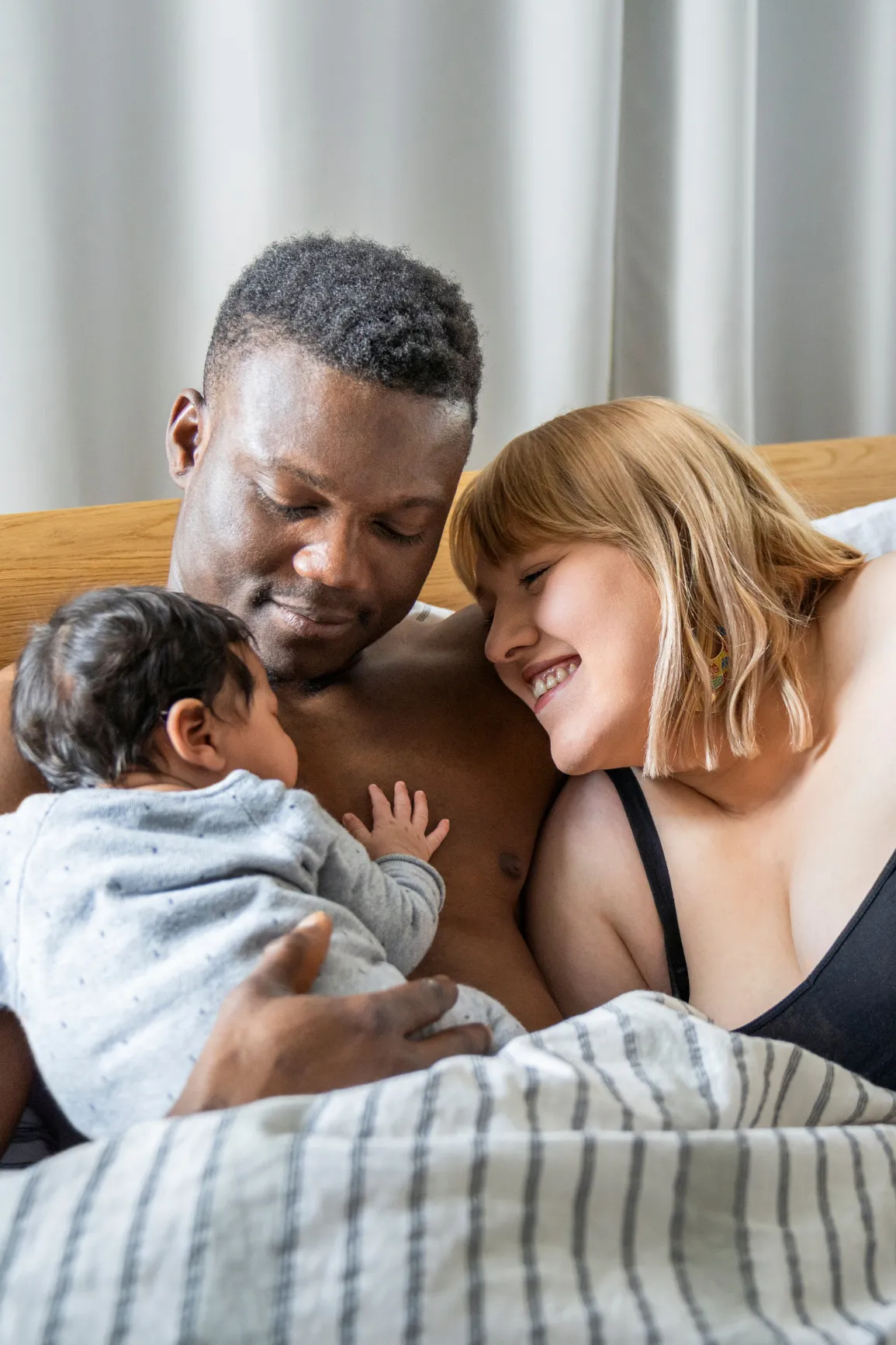 Parents cuddling with baby
